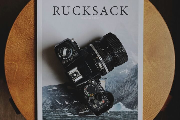 black DSLR camera on Rucksack book